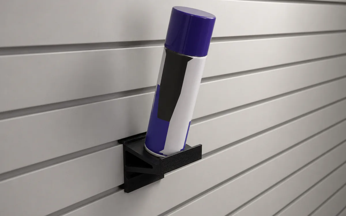 Angled spray-can shelf on slatwall, holding a spray can