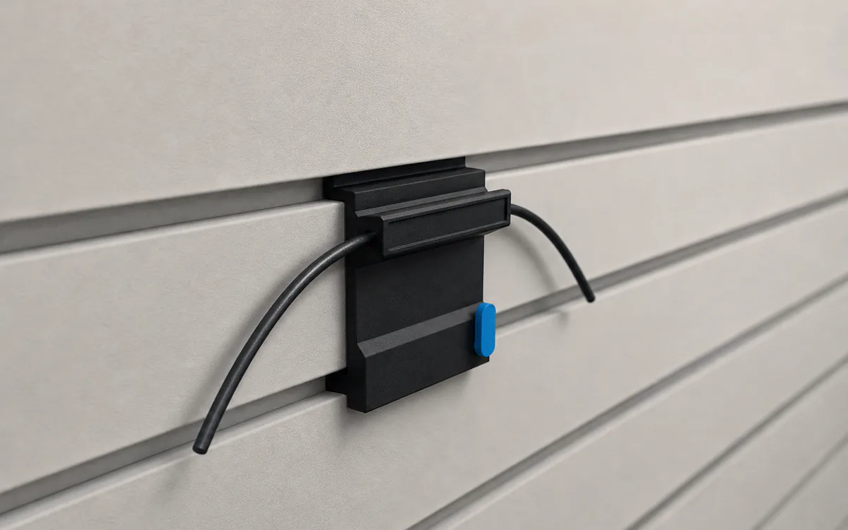 Cable channel on slatwall, holding three cables