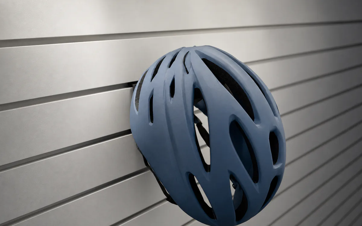 Helmet holder on slatwall, holding a bike helmet
