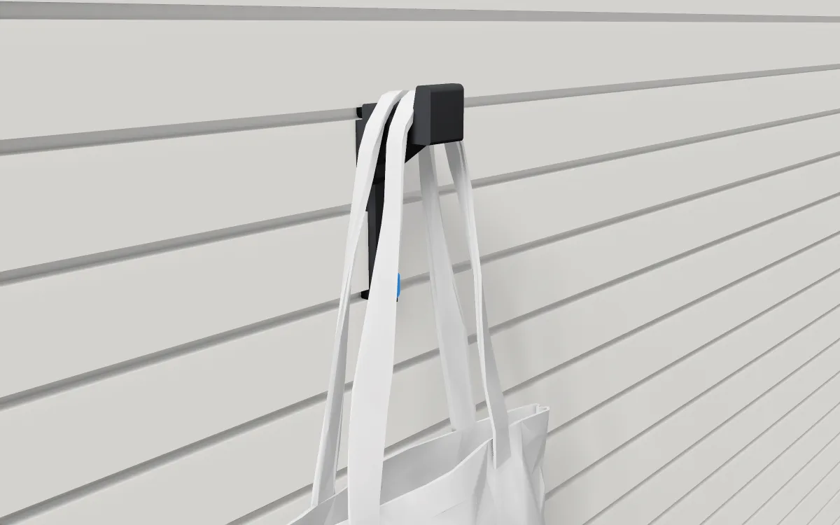 Long locking bag hook on slatwall, holding a canvas tote bag by its handles