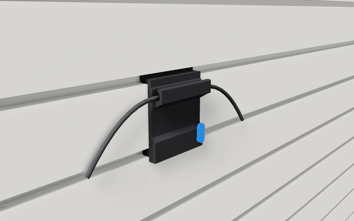 Cable channel on slatwall, holding three cables